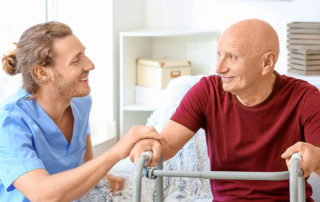 Elderly man with caregiver in nursing home